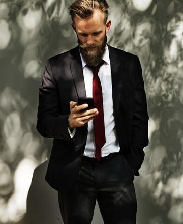 Suited man using mobile responsive website